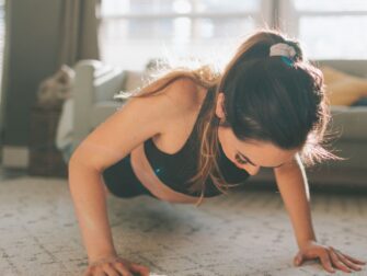 woman doing pushup in living room